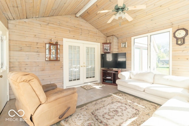 living room featuring beamed ceiling, wood walls, french doors, high vaulted ceiling, and wooden ceiling