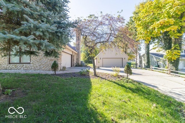1205 Ivywood Ct, New Castle, IN 47362 - view of property exterior with a lawn, concrete driveway, a garage, and stone siding