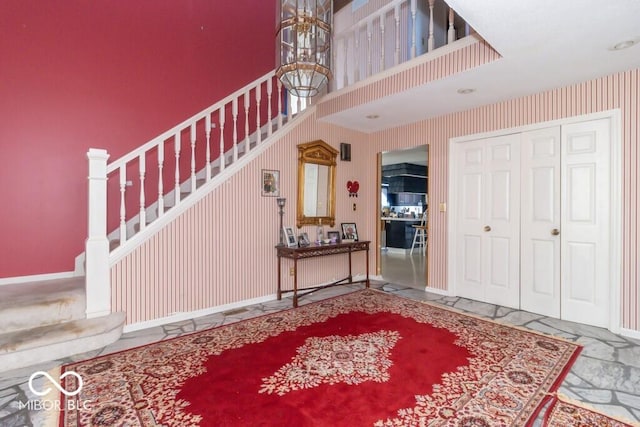 1205 Ivywood Ct, New Castle, IN 47362 - foyer featuring baseboards, stairs, and a chandelier