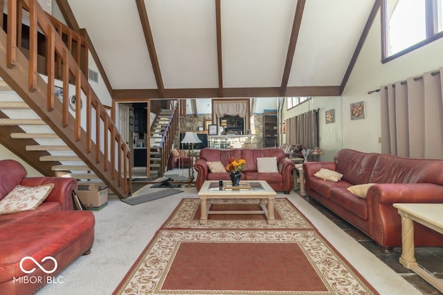 carpeted living room with high vaulted ceiling and beam ceiling