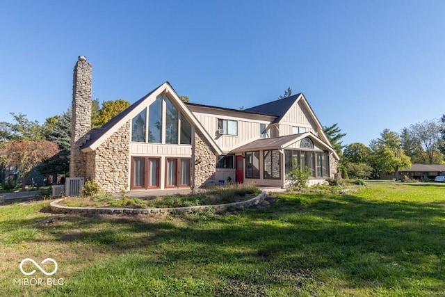 1205 Ivywood Ct, New Castle, IN 47362 - rear view of property with board and batten siding, a lawn, a chimney, and stone siding