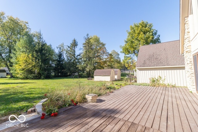 wooden deck with a yard and a shed