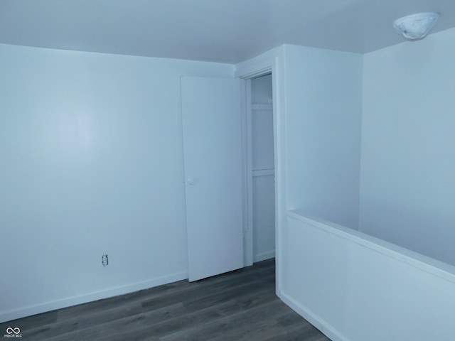 unfurnished room with dark hardwood / wood-style flooring