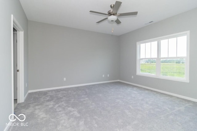 carpeted empty room featuring ceiling fan