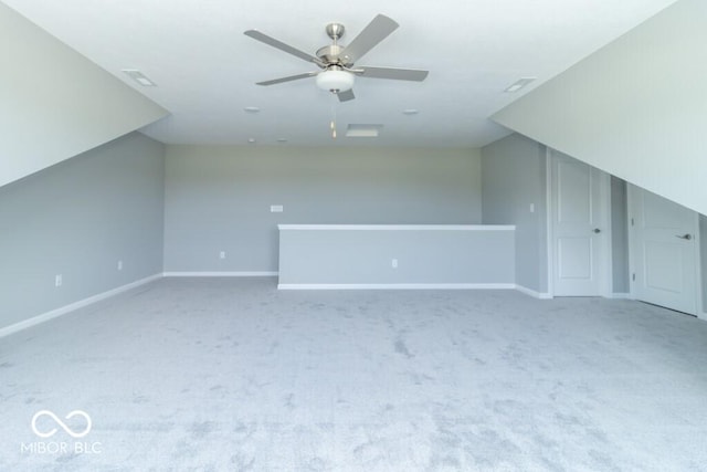 bonus room featuring ceiling fan and carpet