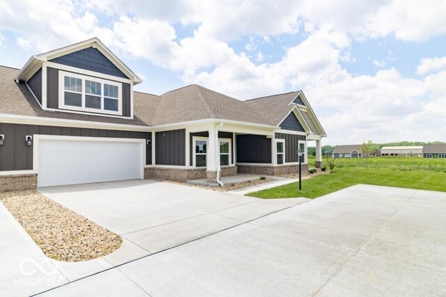 craftsman-style house with a front lawn and a garage