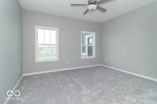 carpeted spare room featuring ceiling fan