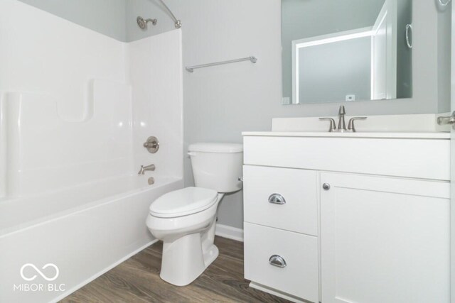 full bathroom featuring bathtub / shower combination, wood-type flooring, vanity, and toilet