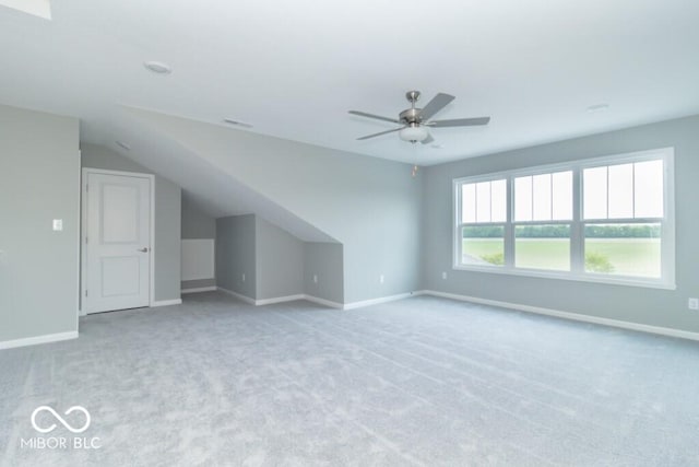 additional living space with light carpet, ceiling fan, and lofted ceiling