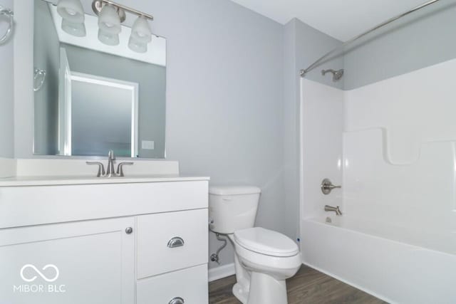 full bathroom with vanity, shower / bath combination, toilet, and hardwood / wood-style flooring