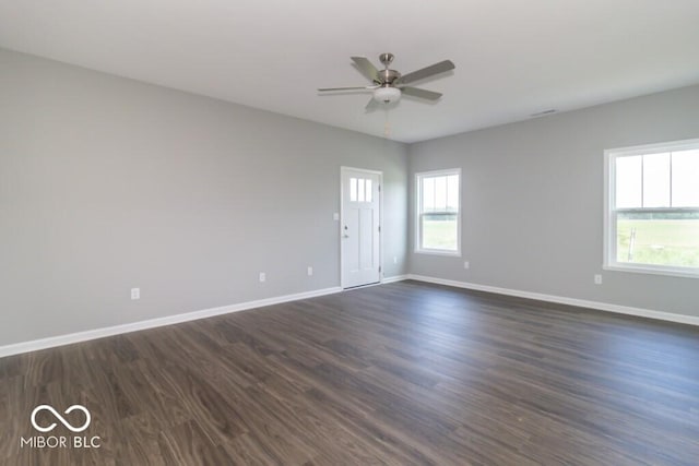 spare room with ceiling fan and dark hardwood / wood-style flooring