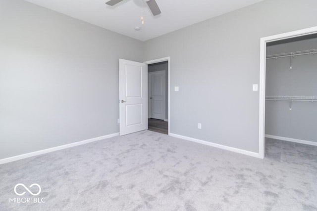 unfurnished bedroom featuring carpet flooring, ceiling fan, and a closet