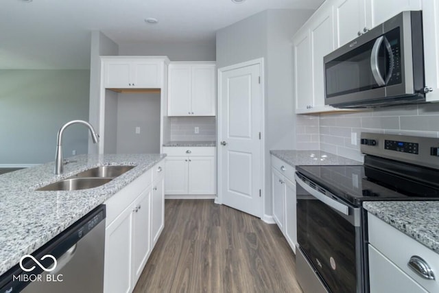 kitchen featuring light stone countertops, sink, white cabinetry, and stainless steel appliances