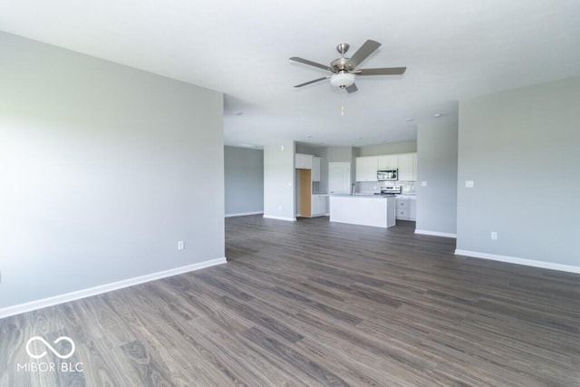 unfurnished living room featuring dark hardwood / wood-style flooring and ceiling fan