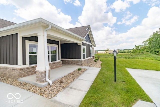 view of side of property with a lawn