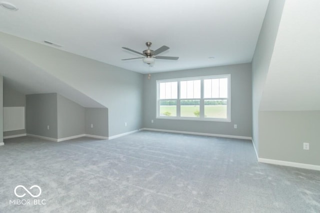 additional living space with light carpet and ceiling fan