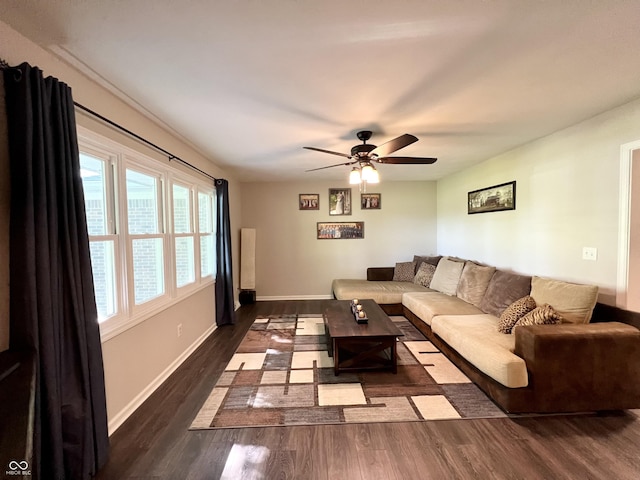 living room with baseboards, ceiling fan, and wood finished floors