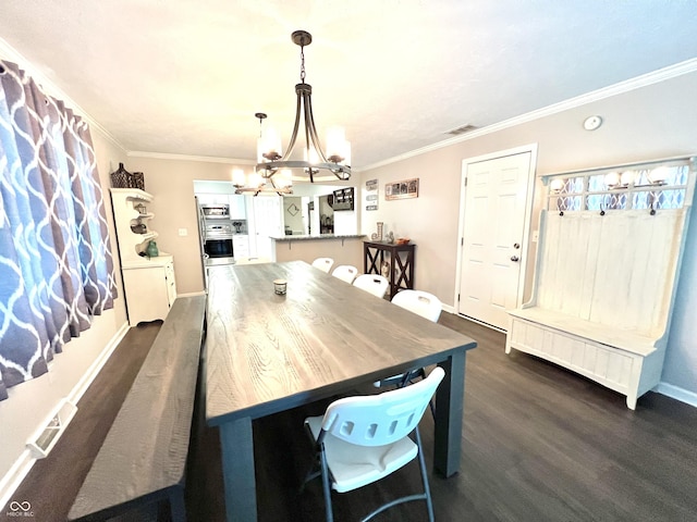 dining space with visible vents, dark wood finished floors, baseboards, a notable chandelier, and ornamental molding
