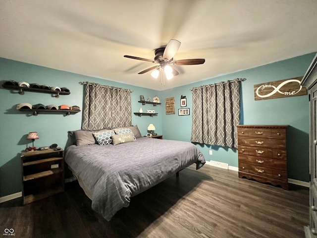 bedroom featuring baseboards, a ceiling fan, and wood finished floors