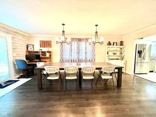 dining space with a chandelier, ornamental molding, and dark wood finished floors