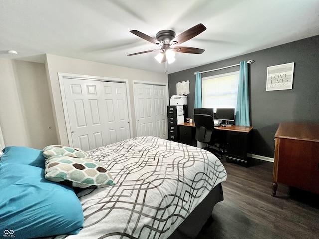 bedroom with multiple closets, baseboards, dark wood-style flooring, and ceiling fan
