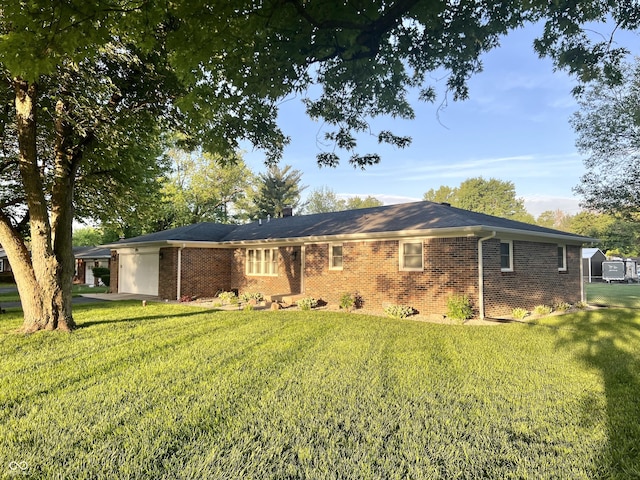 ranch-style home featuring a front yard and brick siding