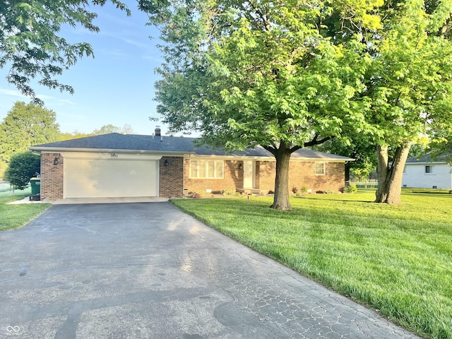 single story home featuring brick siding, an attached garage, driveway, and a front yard