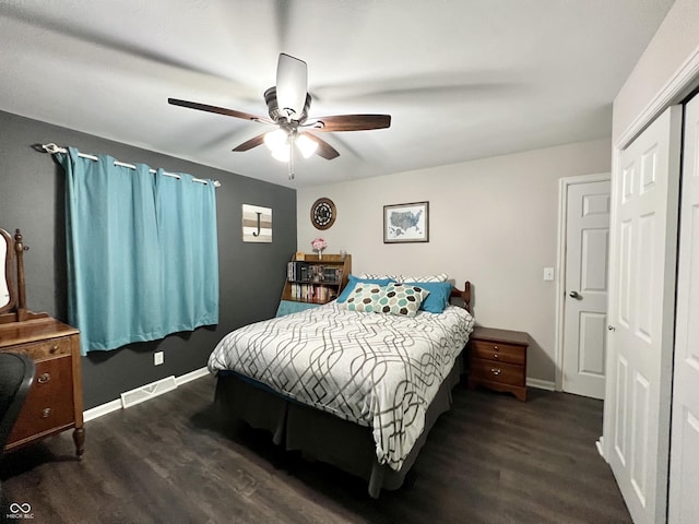 bedroom with dark wood-type flooring, baseboards, and visible vents