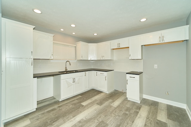 kitchen featuring white cabinetry, tasteful backsplash, and light hardwood / wood-style flooring