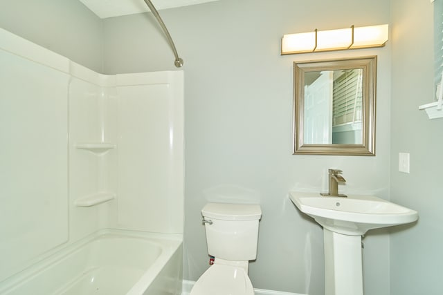 bathroom with shower / bathing tub combination and toilet