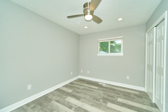 spare room with light hardwood / wood-style flooring and ceiling fan