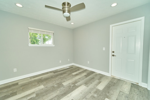 spare room featuring light hardwood / wood-style floors and ceiling fan