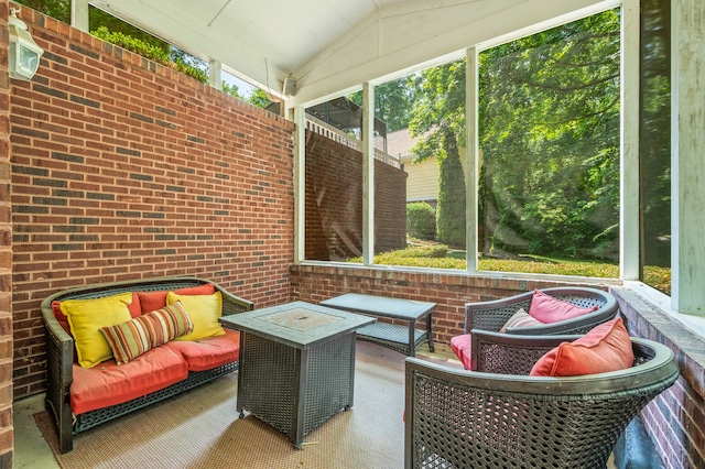 sunroom featuring lofted ceiling