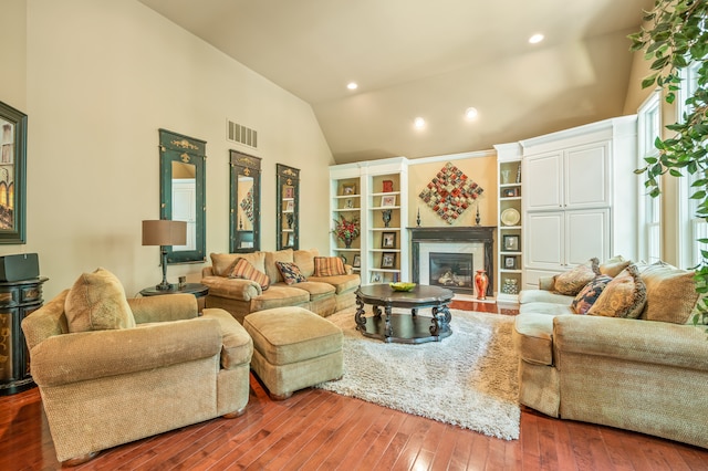 living room with dark hardwood / wood-style flooring and high vaulted ceiling