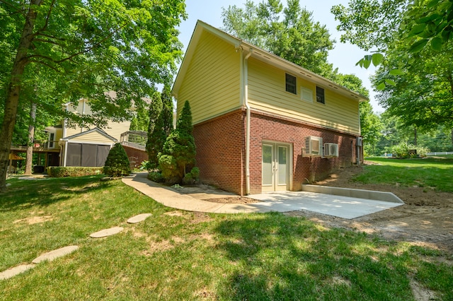 rear view of house featuring a lawn and a patio area