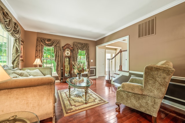 living room with crown molding and dark wood-type flooring