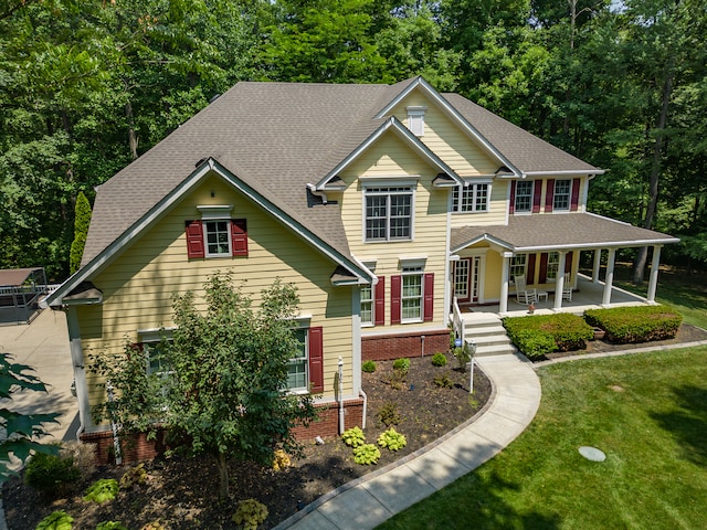 view of front of property with a front yard and a porch