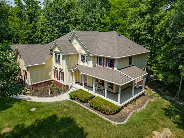 view of front of home with a porch and a front lawn