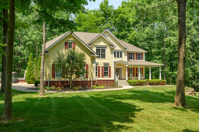 view of front facade with a front yard and covered porch