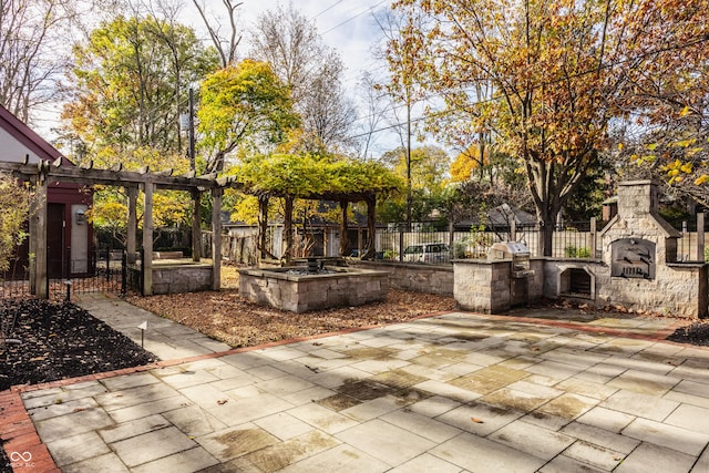 view of patio / terrace featuring a grill and an outdoor stone fireplace