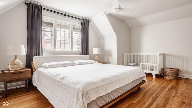 bedroom featuring hardwood / wood-style flooring, ceiling fan, and vaulted ceiling