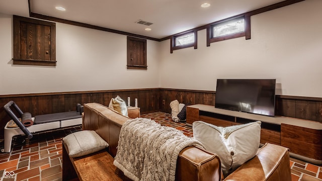 living room featuring crown molding and wood walls