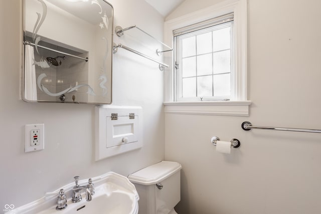 bathroom with sink, vaulted ceiling, and toilet