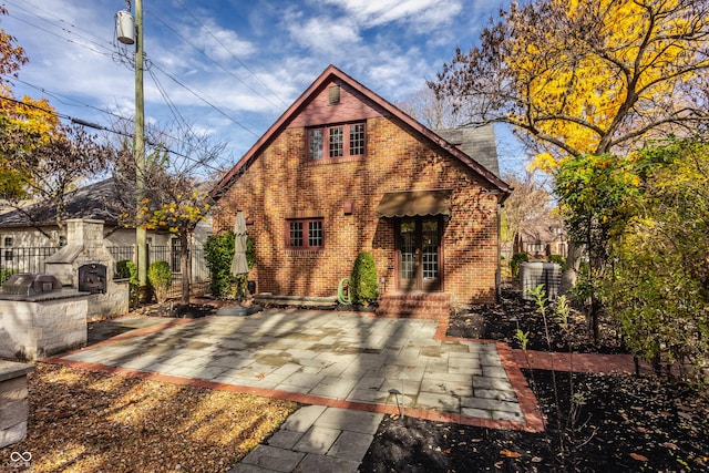 rear view of house featuring a patio and an outdoor kitchen