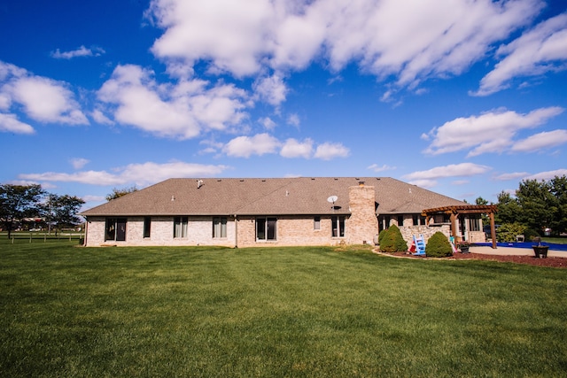 back of property featuring a lawn