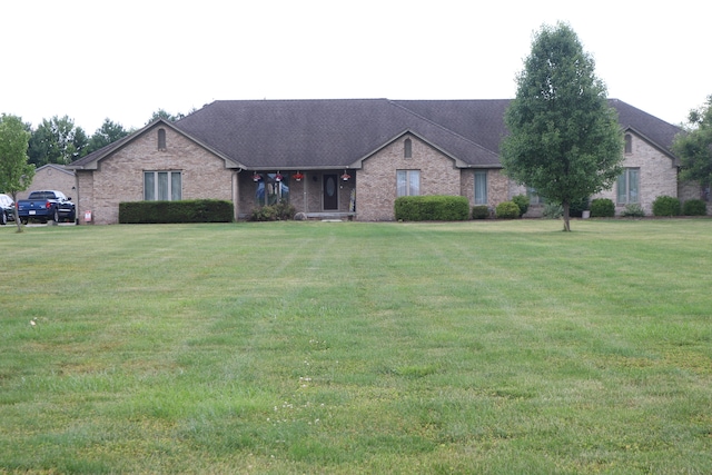 single story home featuring a front lawn