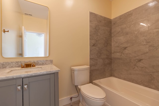 full bathroom with tiled shower / bath combo, toilet, and vanity