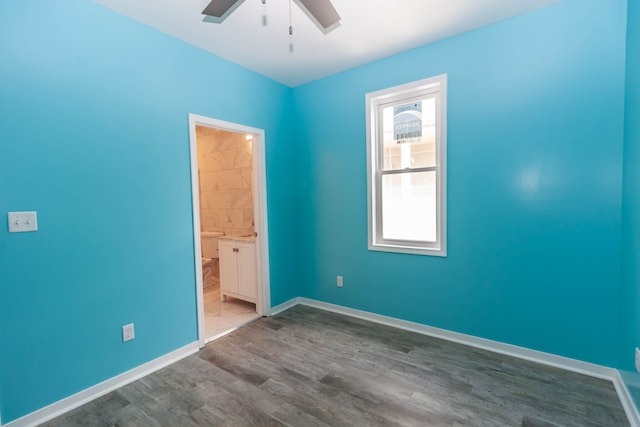 spare room with ceiling fan and dark hardwood / wood-style floors