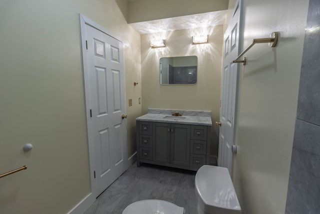 bathroom featuring tile floors, toilet, and vanity