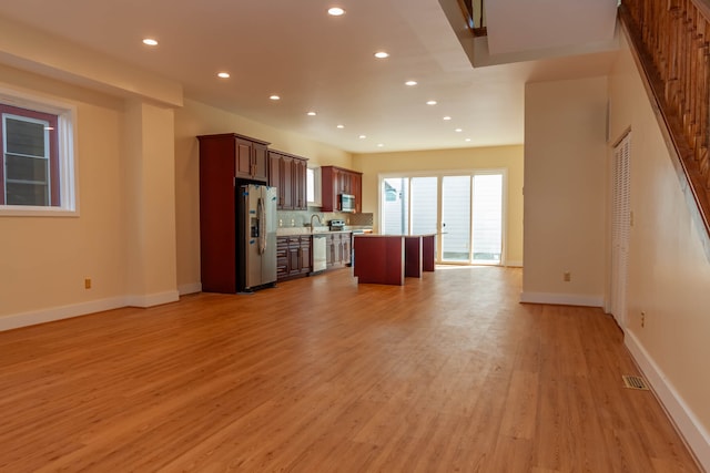 unfurnished living room featuring light wood-type flooring